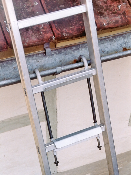 Vergrößerung des Bildes für Leiter ist mit Leiterhacken an einer Dachrinne abgesichert.